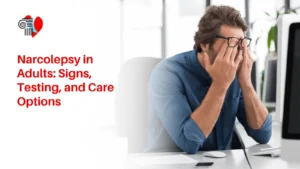 Exhausted adult man wearing glasses rubbing his eyes at an office desk, illustrating excessive daytime sleepiness and narcolepsy signs.